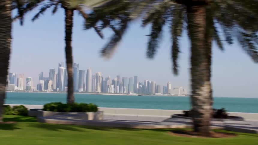 Landscape view of a beach and water with the city skyline in the distance
