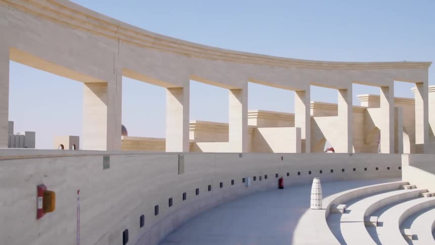 Ornate architecture composed of white stone includes columns and steps