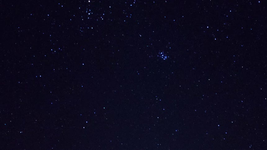 Shooting star flashes across night sky full of stars
