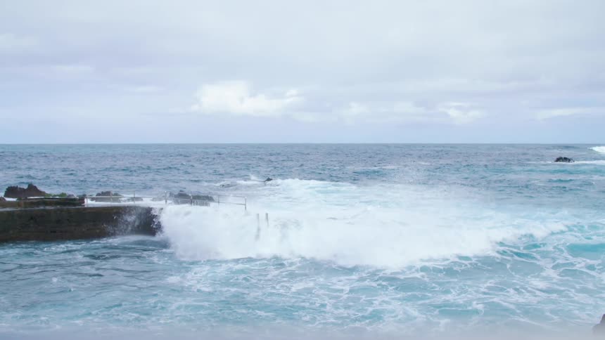 Waves crashing over a dock