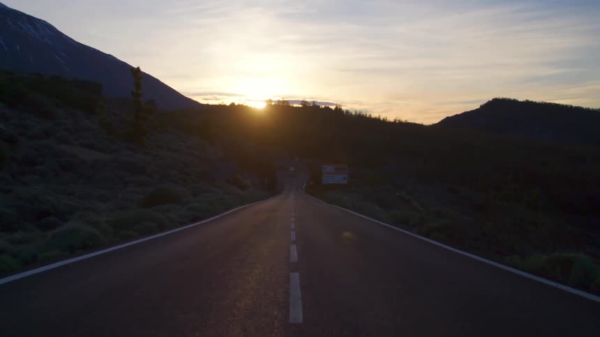 The sun rises over a rural highway