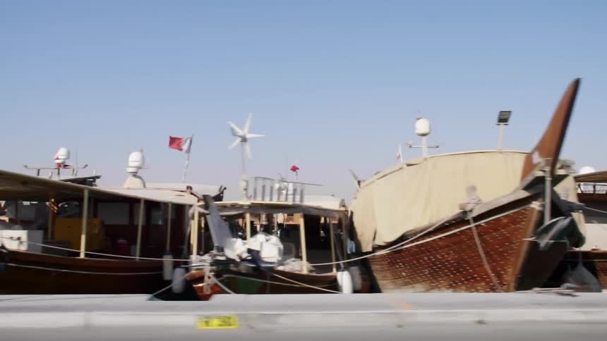 Boats parked in a pier next to the streets