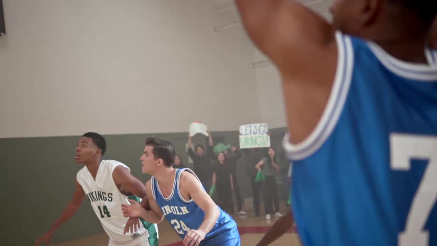 A black teen takes a free throw in a basketball game