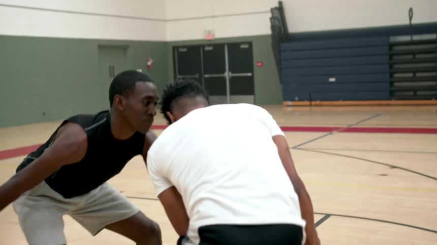 Men playing basketball in a gym
