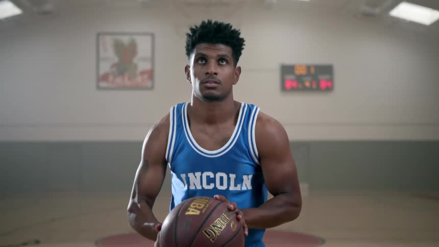 A man prepares to shoot the basketball