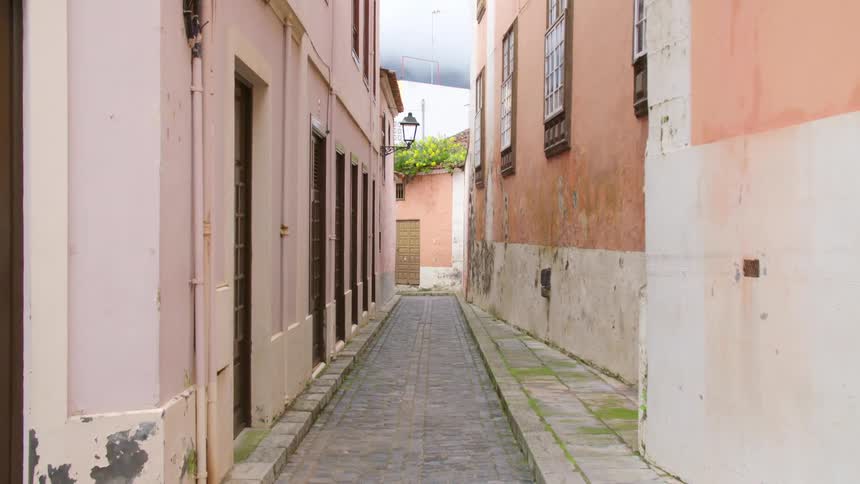 The alley is empty between the buildings