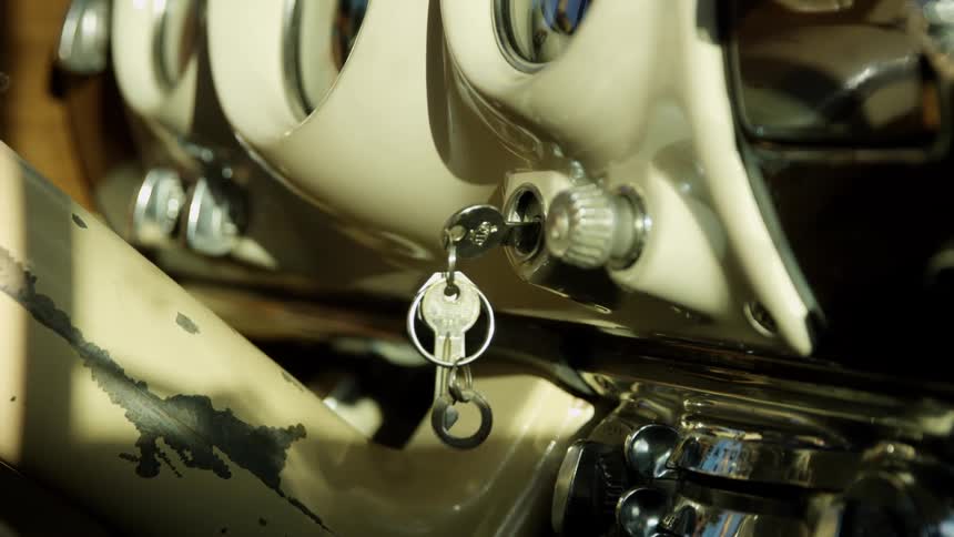 Keys sit in the ignition of a vintage car