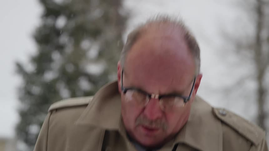 A family doctor walks outside as it snows