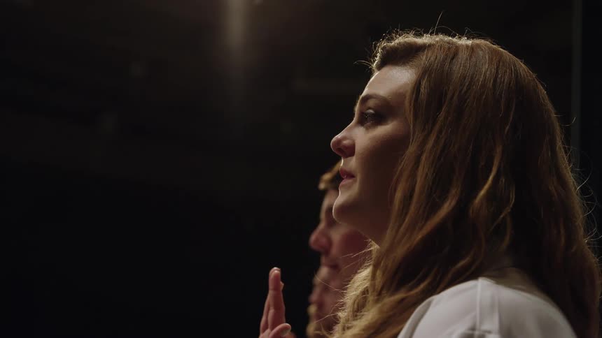 Three people stand and make a pledge