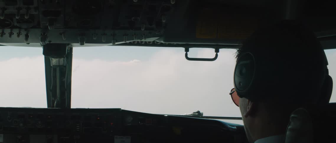 A pilot is flying a helicopter