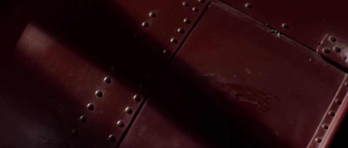 A metal exterior of a vintage plane with rivets holding pieces together