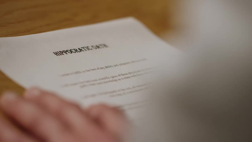 A doctor reads a hippocratic oath