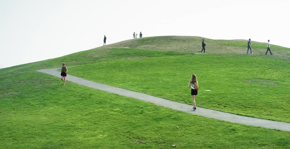 People walking up and down a hill