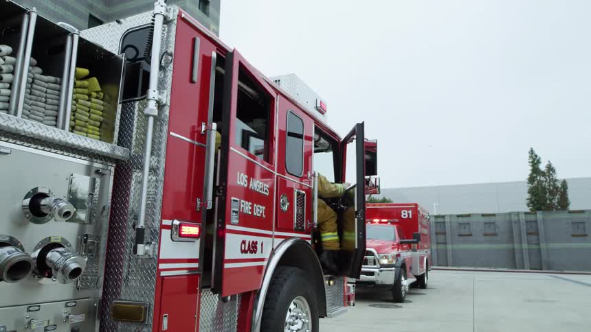 Firemen jump out of the fire truck