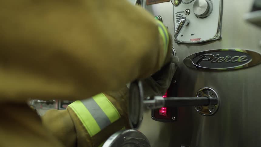 A firefighter adjusts some equipment