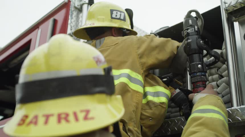 Two firefighters are responding to a scene