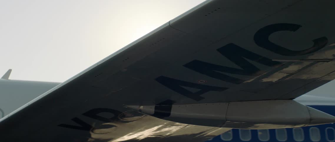 An airplane with the sky and the sun above
