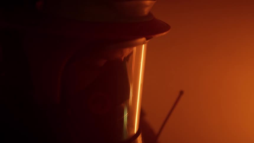 A firefighter looks around a smoke filled room