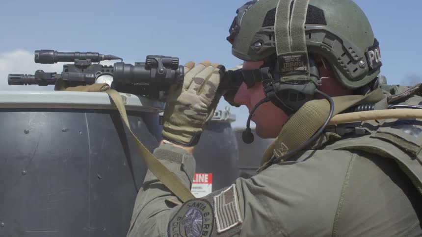 A police officer practices shooting outdoors
