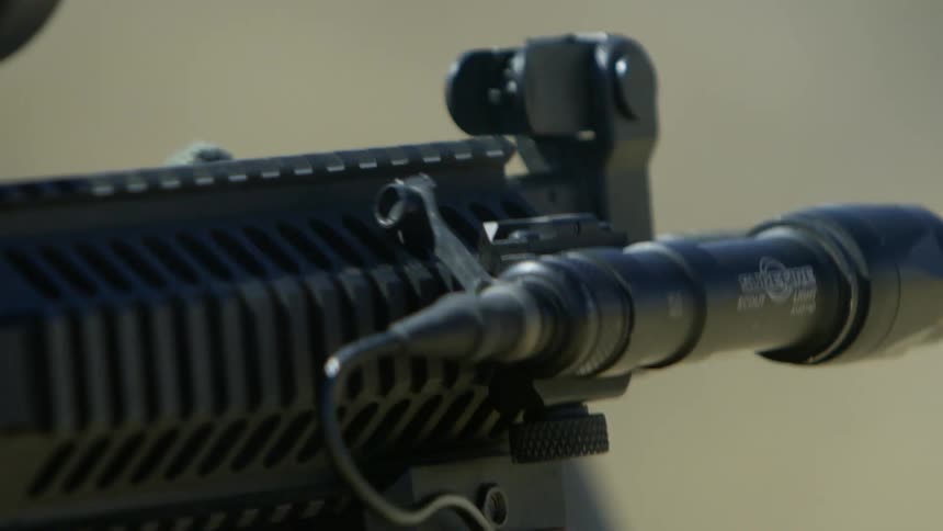 An assault rifle fires a round