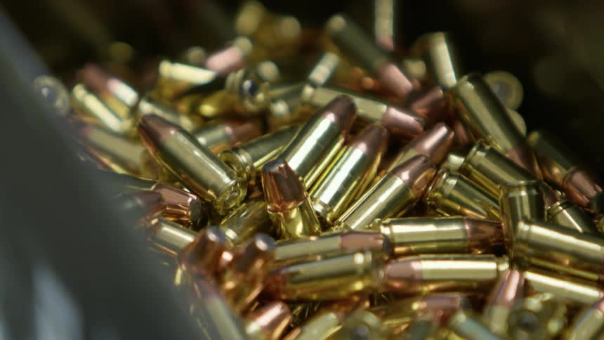 Pile of brass bullets in a box