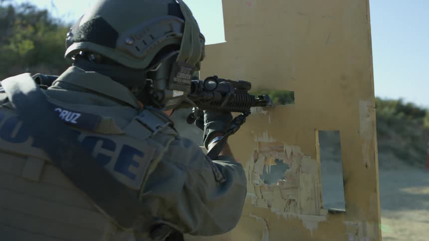 A military policeman shoots his gun at targets