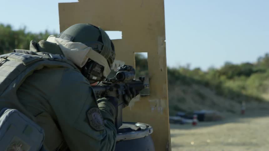 A soldier practices shooting at a target