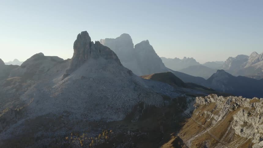Mist covers mountains in background with some mountains in light and others in shadow