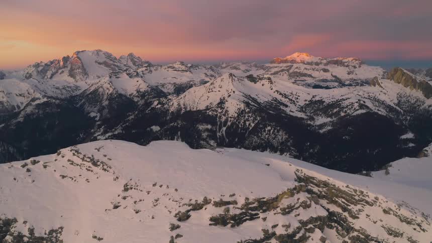 Snow covers the peaks of a mountain range