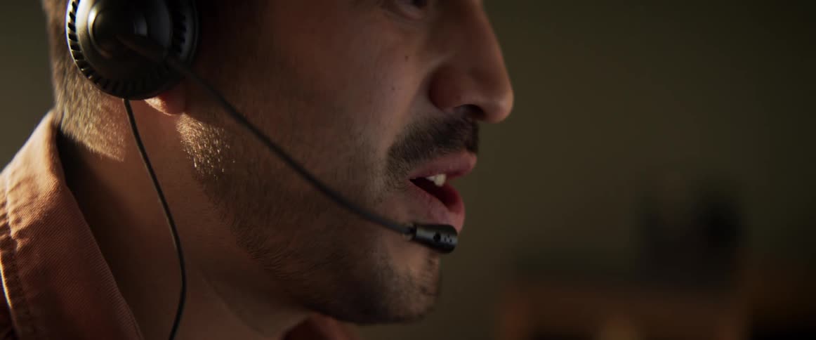 A man is talking on a headset