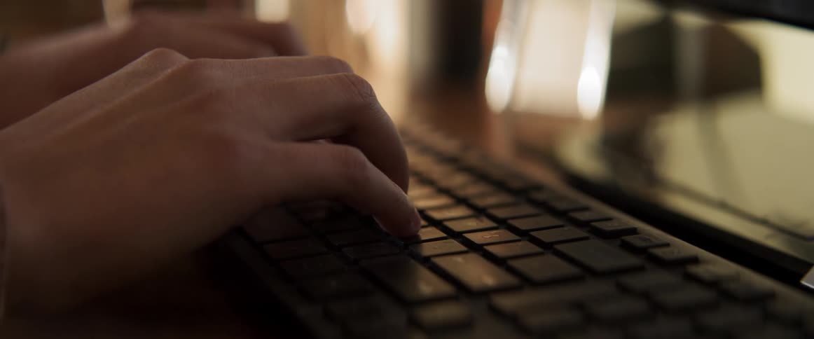 A person types quickly on a keyboard