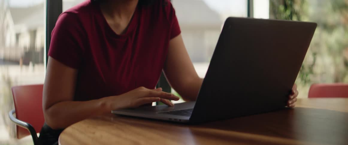 A woman is using her laptop