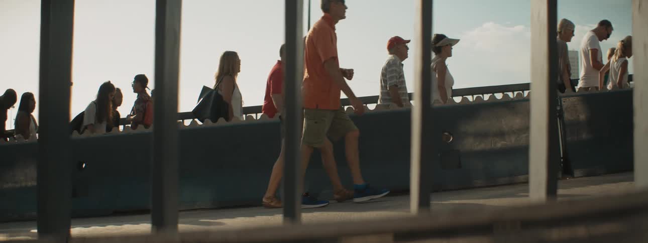 People walk near the pillar