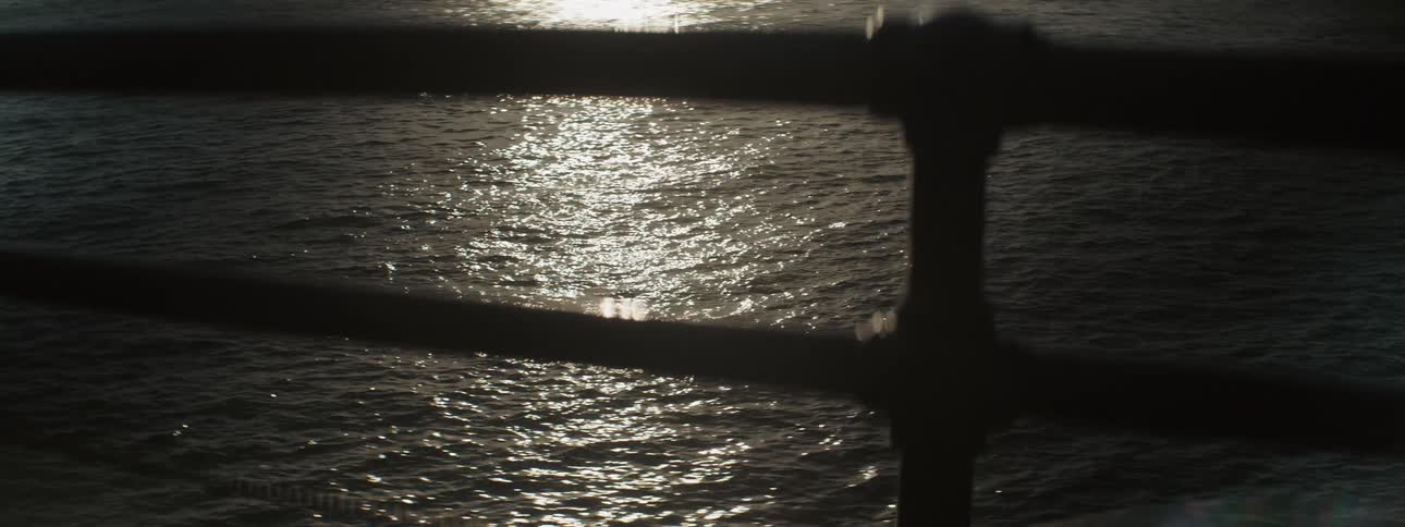 Moonlight shines on the surface of the rippling water