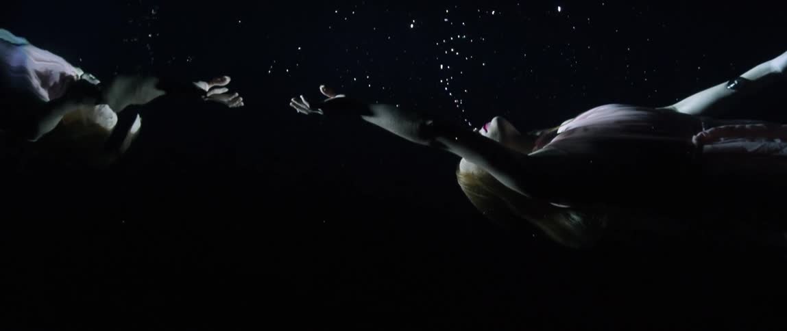 A clothed woman underwater