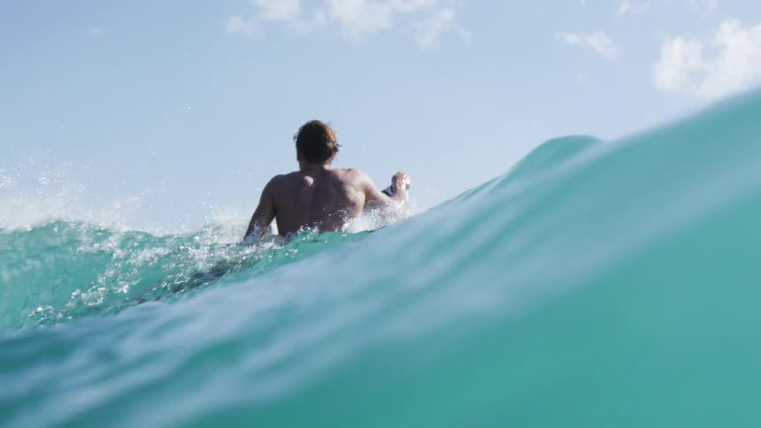A man and others surfing in the ocean