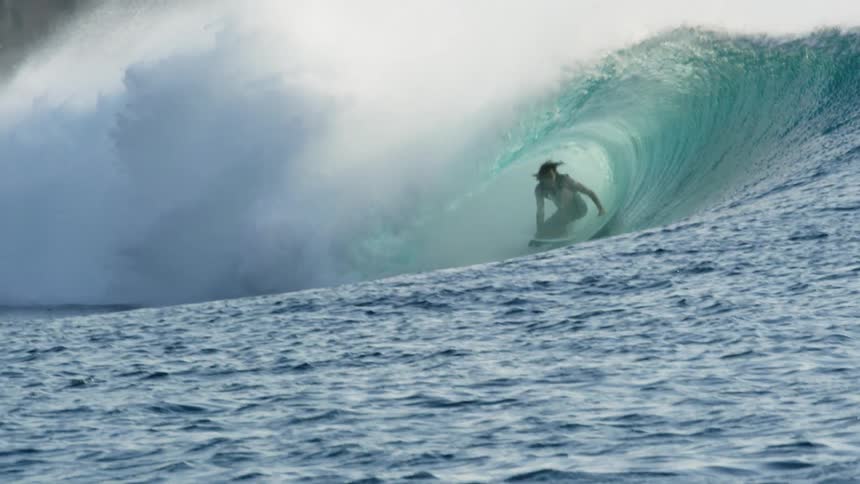 A man surfing on a large wave