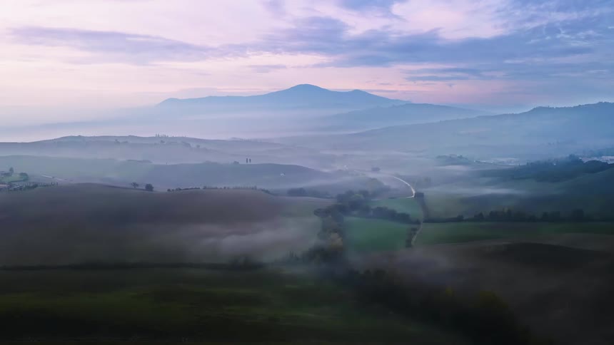 Aerial view of a field with the hills in the background