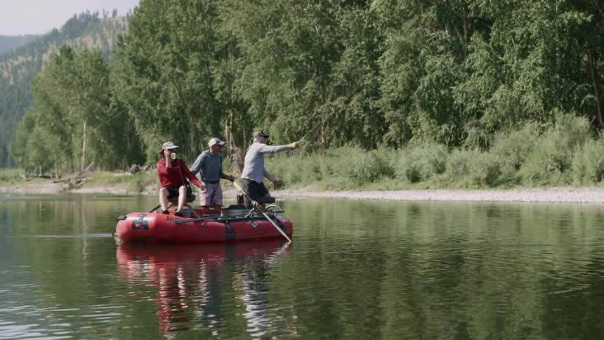 Three men fish together on the raft