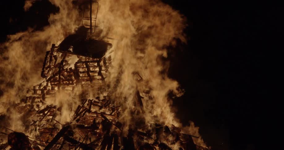 Flames engulf a building at night