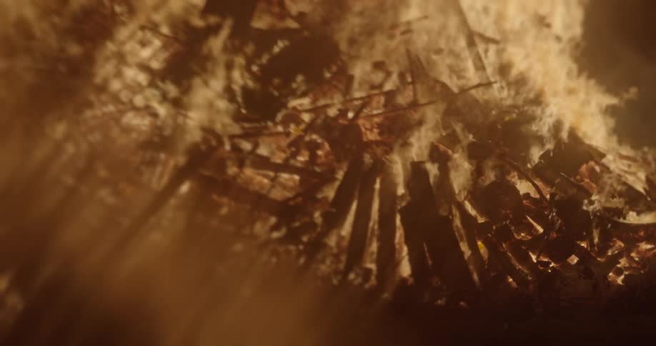 An enormous bonfire rages outdoors