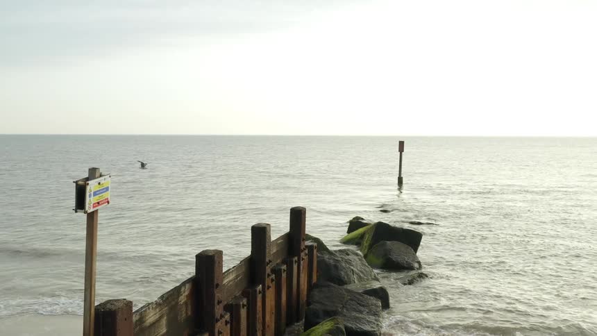 Water breaker in the shoreline of a beach goes into the ocean