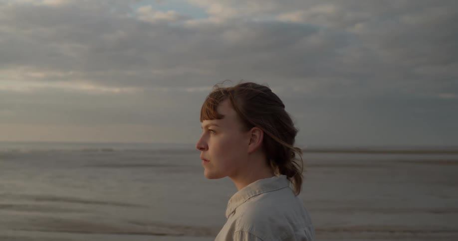A woman is walking on the beach