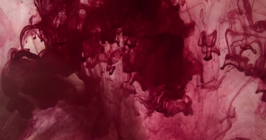 Red ink flowing down inside a water tank