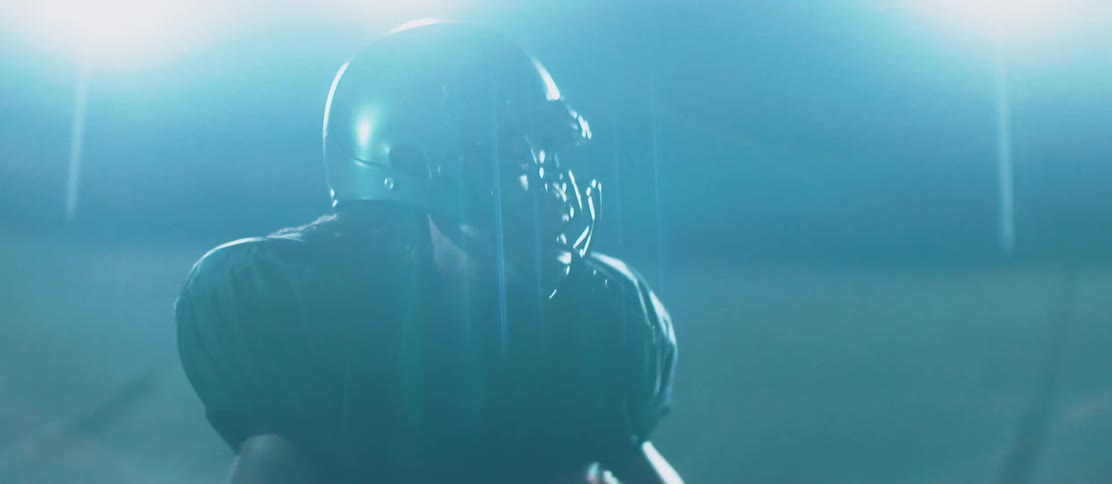 A black quarterback throws a football during a game