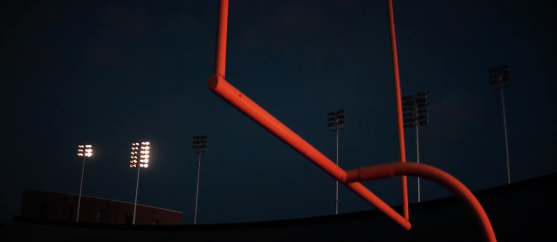 Goal post in football stadium at night