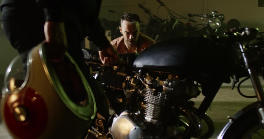 Two men looking at a motorcycle