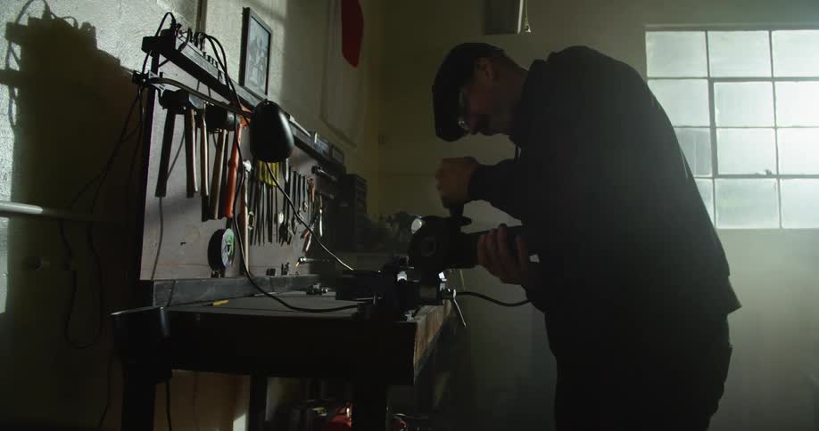 A man welding in a garage