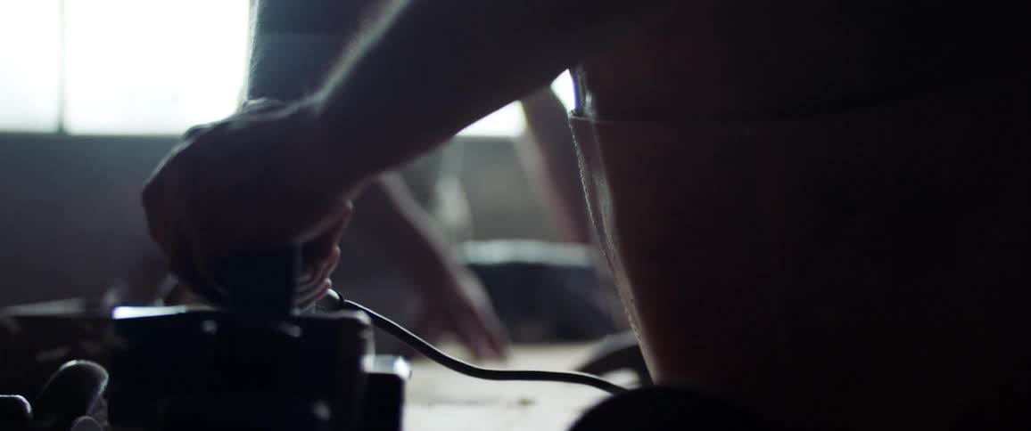 A man using a tool indoors