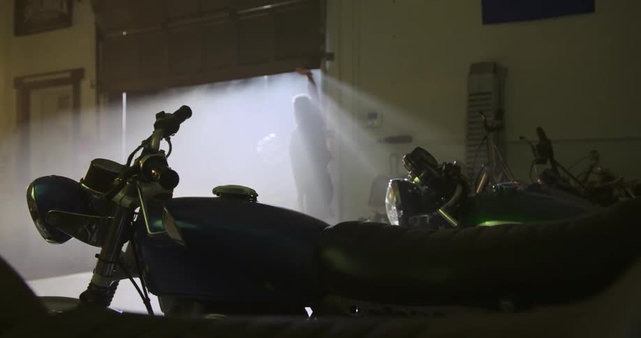 Man drives and parks motorcycle inside a building
